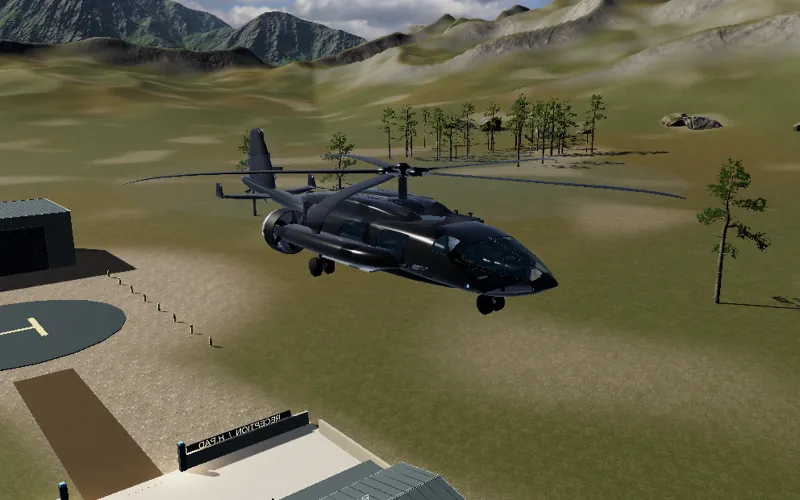 HELIWOLF climbing away from a helipad and hangar in a mountain valley